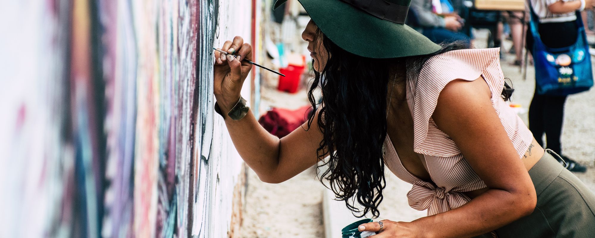 Woman painting details on wall