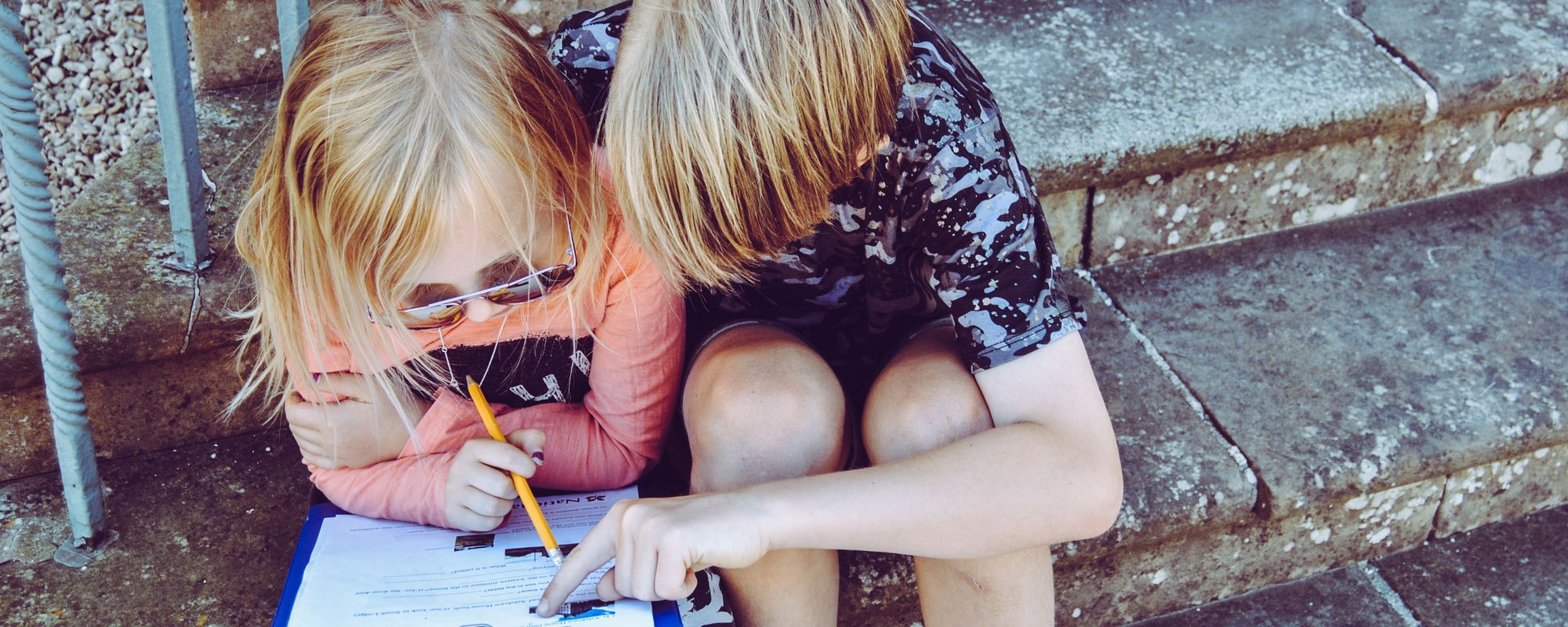 Boy and girl studying a clipboard