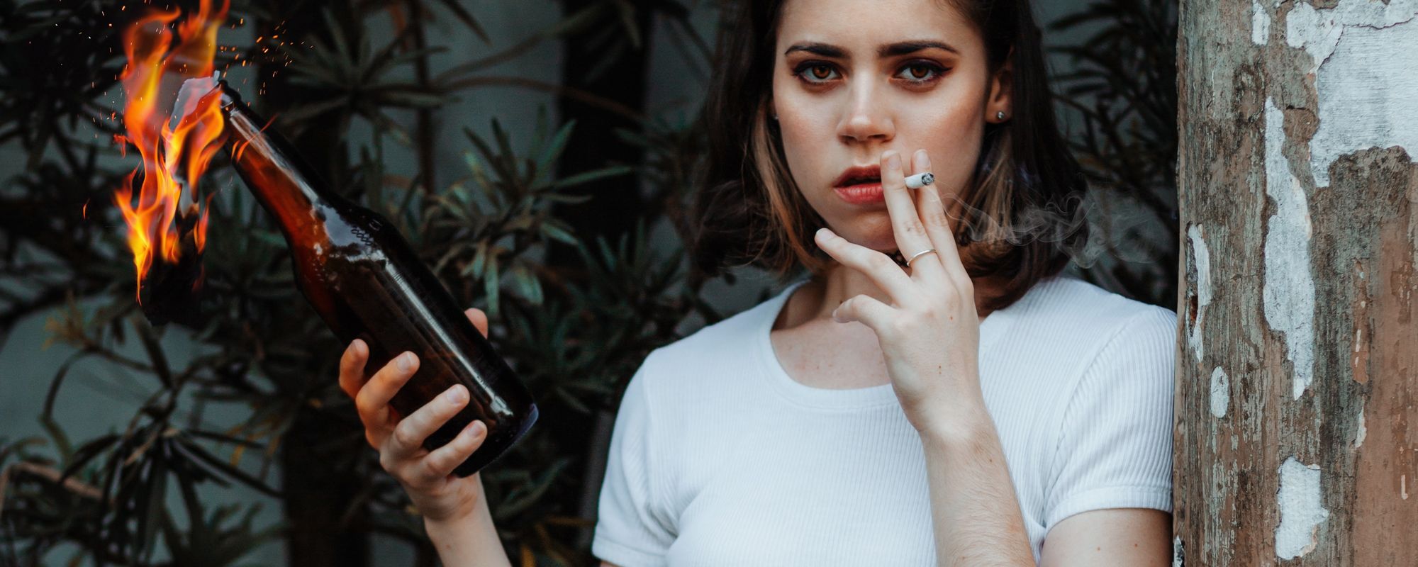 Girl smoking and holding a Molotov cocktail