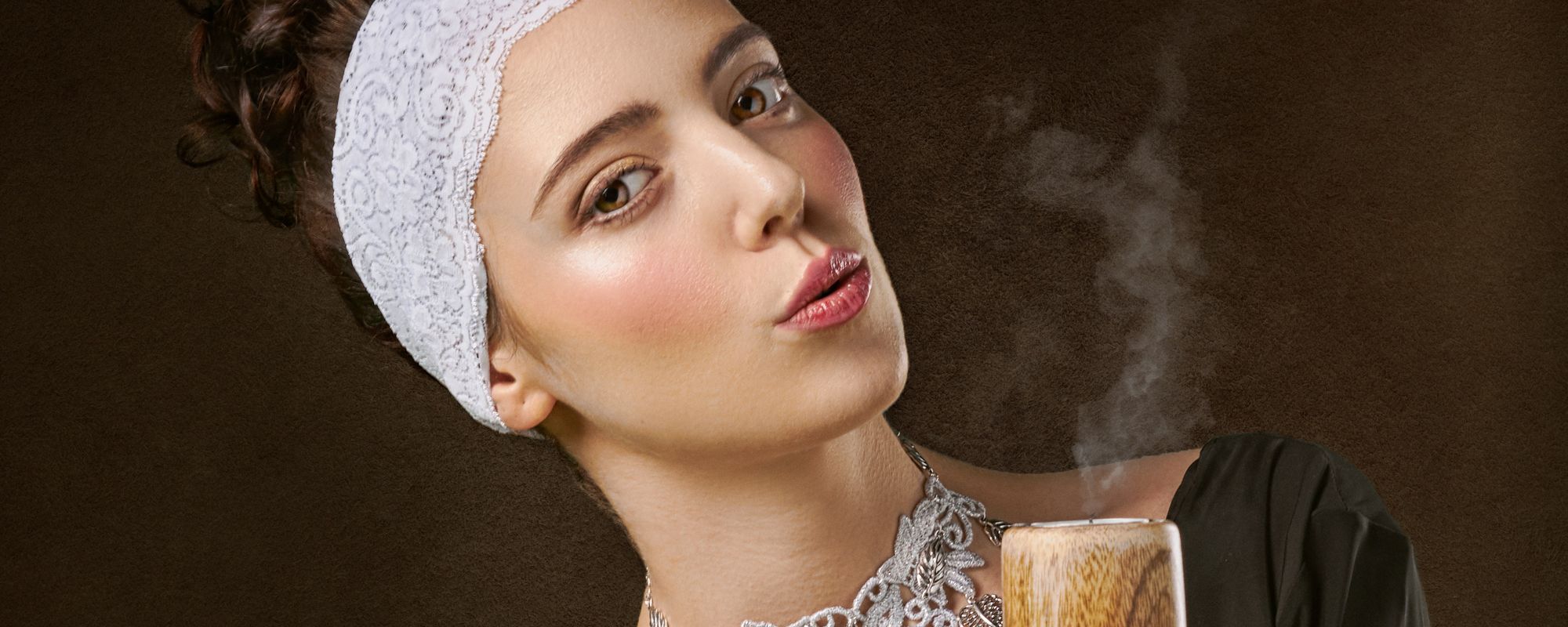Woman seductively blowing a candle