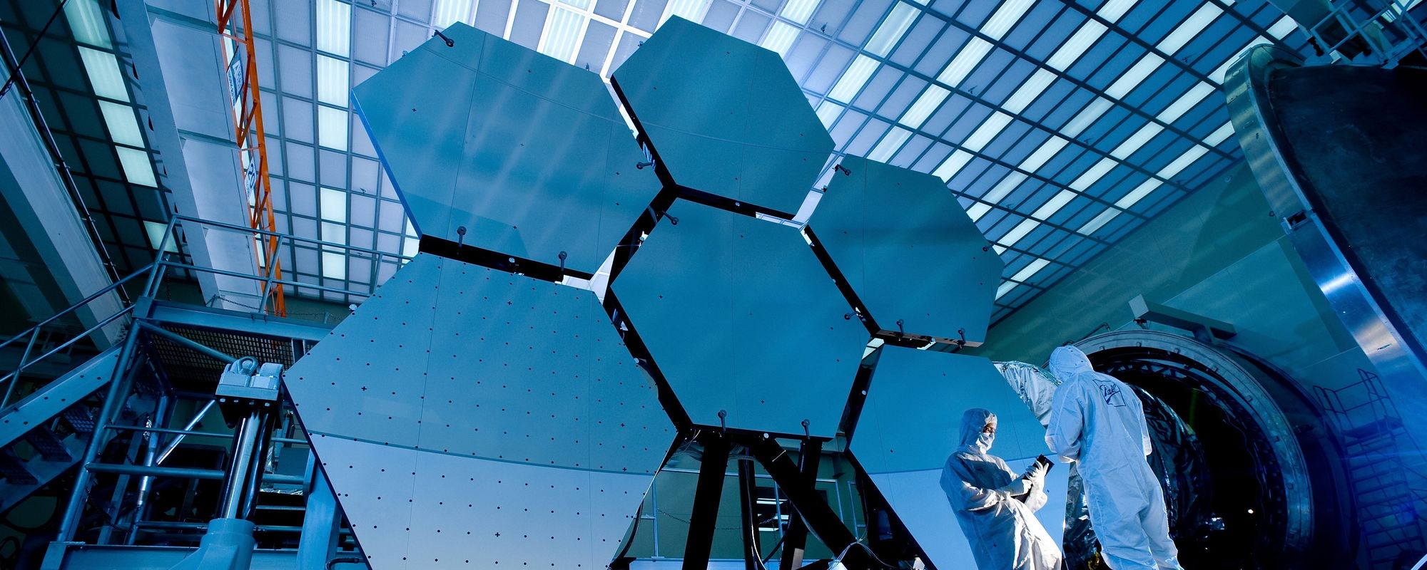 Technician in suit in front of panels