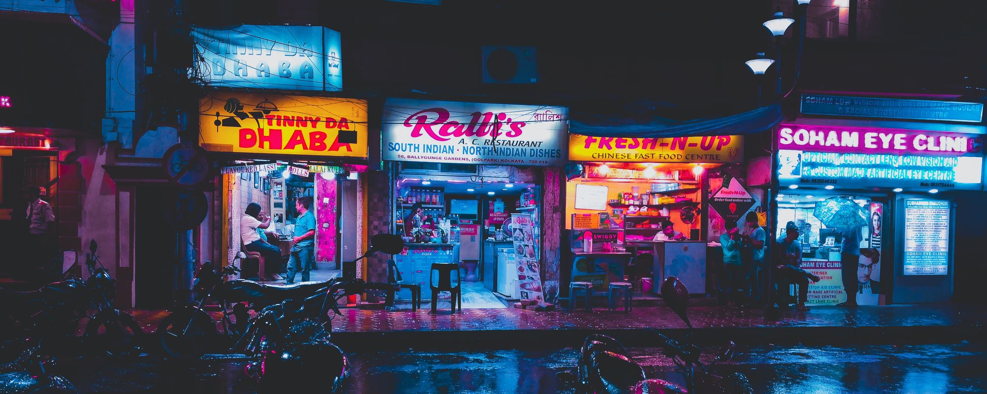 Row of Indian shops and restaurants, after rain